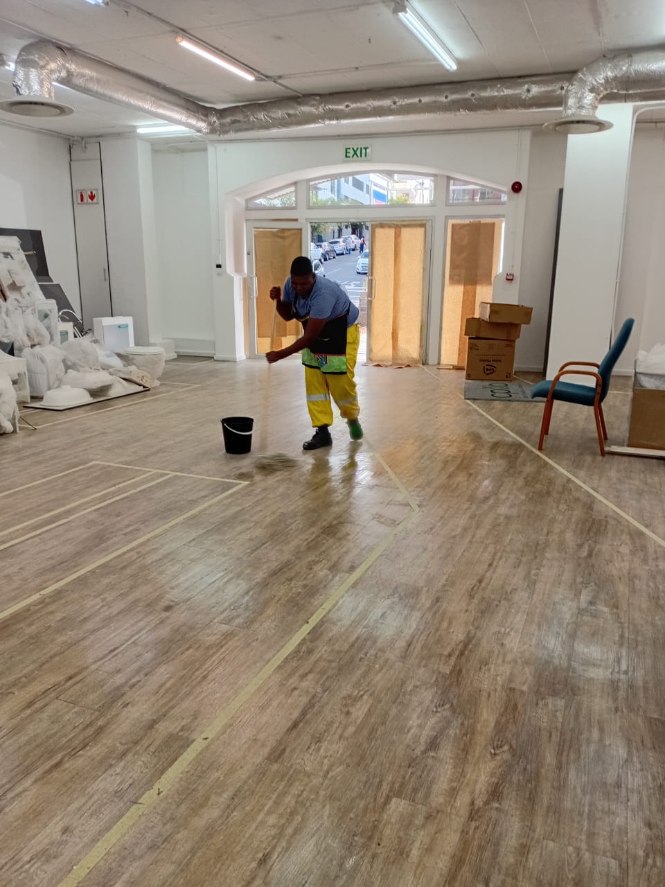 Worker mopping a large commercial floor area